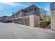 Two-story building featuring an open-air patio, attached garages, and desert landscaping at 1847 Avacado Ct, Henderson, NV 89014