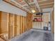 Unfinished garage featuring exposed framing, lots of storage space, and a concrete floor at 1847 Avacado Ct, Henderson, NV 89014