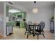Bright kitchen and dining area with a round table, green cabinets, and stainless steel appliances at 1847 Avacado Ct, Henderson, NV 89014