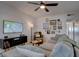 Comfortable living room boasts a large TV, ceiling fan, and curated gallery wall at 1847 Avacado Ct, Henderson, NV 89014