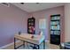 This home office features hardwood floors, a simple desk with decor and shelving units for storage at 1847 Avacado Ct, Henderson, NV 89014