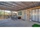 Cozy outdoor patio with a pergola, dining table, and access to sliding glass doors at 1847 Avacado Ct, Henderson, NV 89014