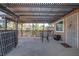 Covered patio features a dining table with seating, a decorative fence, and landscaping at 1847 Avacado Ct, Henderson, NV 89014