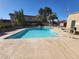 Community pool surrounded by a concrete deck, lounge chairs, and beautiful landscaping at 1847 Avacado Ct, Henderson, NV 89014