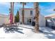 Private backyard patio area featuring ample seating space and mature palm trees, perfect for outdoor entertaining at 2042 Waverly Cir, Henderson, NV 89014