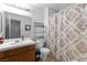 Full bathroom with neutral patterned shower curtain and vanity at 2042 Waverly Cir, Henderson, NV 89014