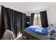 Cozy bedroom featuring a window, dark curtains, and comfortable bed, creating a peaceful and private retreat at 2042 Waverly Cir, Henderson, NV 89014