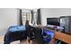 Modern bedroom boasts large computer setup with cozy sleeping space at 2042 Waverly Cir, Henderson, NV 89014