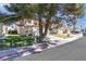 Charming home featuring mature landscaping, a well-maintained lawn, and a welcoming front entrance on a sunny day at 2042 Waverly Cir, Henderson, NV 89014