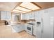 Bright kitchen with white cabinetry, modern appliances, and a window providing natural light for a welcoming atmosphere at 2042 Waverly Cir, Henderson, NV 89014