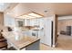 Bright kitchen featuring ample counter space, white appliances, and bar stool seating, perfect for modern living at 2042 Waverly Cir, Henderson, NV 89014