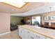 Open-concept living space featuring a bar, dining area, and cozy seating area with a fireplace for relaxed living at 2042 Waverly Cir, Henderson, NV 89014