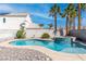 Backyard pool features a spa with waterfall feature, rock landscaping, and privacy wall at 2042 Waverly Cir, Henderson, NV 89014