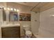 Bathroom with vanity, framed mirror, updated lighting and tiled shower at 2120 Ramrod Ave # 415, Henderson, NV 89014