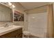 Bathroom with vanity, framed mirror, updated lighting and tiled shower/tub at 2120 Ramrod Ave # 415, Henderson, NV 89014