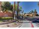 Community entrance sign with desert landscaping and secure gate at 2120 Ramrod Ave # 415, Henderson, NV 89014