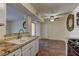 View of kitchen sink and adjacent dining area with ceiling fan and tile flooring at 2120 Ramrod Ave # 415, Henderson, NV 89014