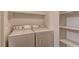 Laundry room with washer, dryer, and shelving for storage at 2120 Ramrod Ave # 415, Henderson, NV 89014