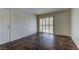 Open living room with tile floors, a door to a closet, and sliding glass doors to the patio at 2120 Ramrod Ave # 415, Henderson, NV 89014