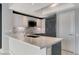 A modern kitchen island with white marble countertops and stylish gray and white cabinetry at 222 Karen Ave # 1904, Las Vegas, NV 89109