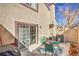 Outdoor patio with grill, seating, potted plants, and a sliding door leading to the interior of the home at 2609 Orchard Meadows Ave, Henderson, NV 89074