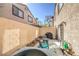 Patio with seating, potted plants, grill and a view of the property's exterior walls and surrounding landscape at 2609 Orchard Meadows Ave, Henderson, NV 89074