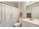 Well-lit bathroom featuring a vanity, toilet, and shower with a decorative gold-dot shower curtain at 2609 Orchard Meadows Ave, Henderson, NV 89074
