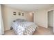 Spacious bedroom featuring neutral walls, carpeted floors, and a comfortable bed with patterned comforter at 2609 Orchard Meadows Ave, Henderson, NV 89074