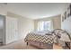 Bright bedroom featuring a zig-zag patterned comforter, neutral walls, and natural light from the window at 2609 Orchard Meadows Ave, Henderson, NV 89074