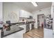 Bright kitchen with stainless steel appliances, black countertops, and modern white cabinetry at 2609 Orchard Meadows Ave, Henderson, NV 89074