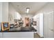 Modern kitchen with white cabinets, black countertops, stainless steel appliances, and an open design at 2609 Orchard Meadows Ave, Henderson, NV 89074