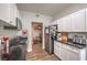Modern kitchen featuring white cabinets, granite countertops, and stainless steel appliances at 2609 Orchard Meadows Ave, Henderson, NV 89074