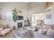 Bright living room featuring high ceilings, fireplace, and modern decor adjacent to the dining area at 2609 Orchard Meadows Ave, Henderson, NV 89074