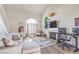 Bright living room showcasing a fireplace, modern furnishings, and a large window for ample natural light at 2609 Orchard Meadows Ave, Henderson, NV 89074