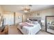 Bright main bedroom with a ceiling fan, plush carpet, and ample closet space at 2609 Orchard Meadows Ave, Henderson, NV 89074