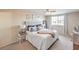 Well-lit main bedroom with a large window, side table, and neutral decor at 2609 Orchard Meadows Ave, Henderson, NV 89074