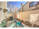 Cozy patio with a seating area, potted plants, and a brick wall creating a private outdoor space at 2609 Orchard Meadows Ave, Henderson, NV 89074