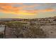 Aerial view of a home overlooking a golf course and desert landscape at sunset at 2920 Foxtail Creek Ave, Henderson, NV 89052