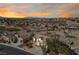 Sunset aerial view of a desert community with mature landscaping and a view of the mountains at 2920 Foxtail Creek Ave, Henderson, NV 89052