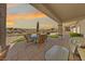 Covered patio with an outdoor dining table and chairs and a putting green at 2920 Foxtail Creek Ave, Henderson, NV 89052