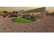 Backyard area with a patio, putting green, hot tub and desert landscaping at 2920 Foxtail Creek Ave, Henderson, NV 89052