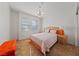 Bright bedroom featuring a queen bed, two windows and wood-look floors at 2920 Foxtail Creek Ave, Henderson, NV 89052