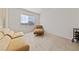Minimalist bedroom features a comfortable sofa, chair, and a storage rack at 2920 Foxtail Creek Ave, Henderson, NV 89052