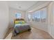 Bedroom featuring a queen bed, wood-look floors, and three windows at 2920 Foxtail Creek Ave, Henderson, NV 89052