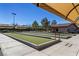 Enjoy the community's bocce ball court featuring a shaded area with covered seating in a well-kept green space at 2920 Foxtail Creek Ave, Henderson, NV 89052