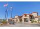 Beautiful clubhouse featuring stucco exterior, tile roof, desert landscaping, and elegant entrance for community members at 2920 Foxtail Creek Ave, Henderson, NV 89052