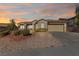 Single-story home featuring a tile roof, desert landscaping, and an attached two-car garage at 2920 Foxtail Creek Ave, Henderson, NV 89052