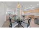 Bright kitchen features a central island, sleek appliances, a glass dining table, and ample cabinet space at 2920 Foxtail Creek Ave, Henderson, NV 89052