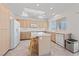 Spacious kitchen featuring a center island, sleek appliances, light wood cabinets, and recessed lighting at 2920 Foxtail Creek Ave, Henderson, NV 89052