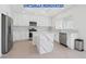 Modern kitchen features updated appliances, white cabinets, and a marble island countertop at 2920 Foxtail Creek Ave, Henderson, NV 89052